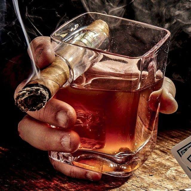 A relaxed individual savoring a cigar in a tranquil outdoor setting, emphasizing the mindful enjoyment and social connection that comes with responsible cigar smoking.